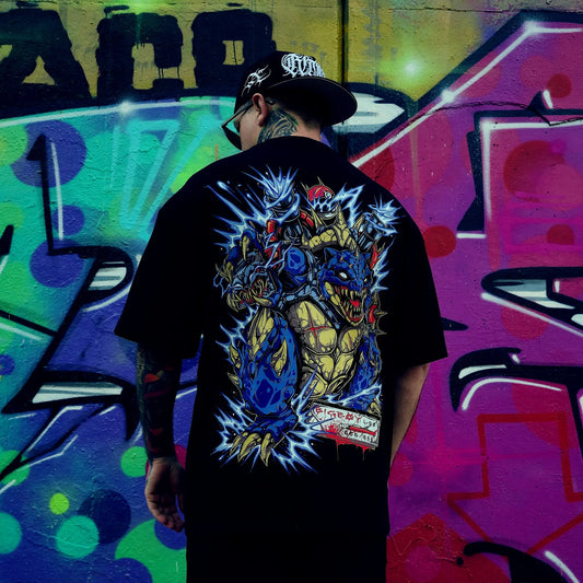 Person wearing a black t-shirt with a colourful graphic design, standing in front of a vibrant graffiti wall. RTLA-Apparel