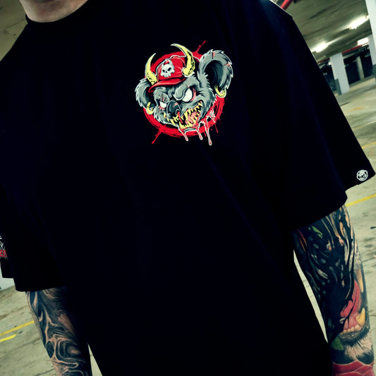 Person wearing a black t-shirt with a colorful graphic design in an indoor setting