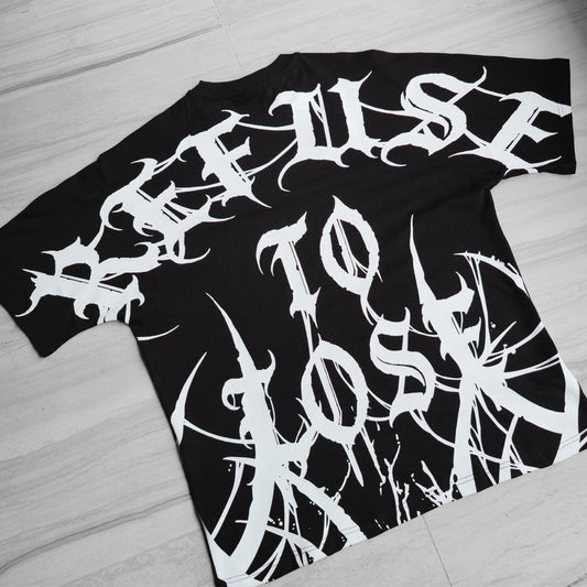 Black t-shirt with white graphic design on a wooden surface
