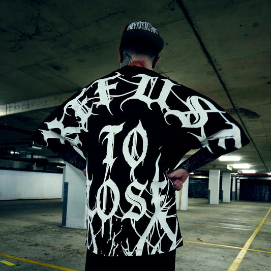 Person wearing a black and white graphic t-shirt in an underground parking lot.