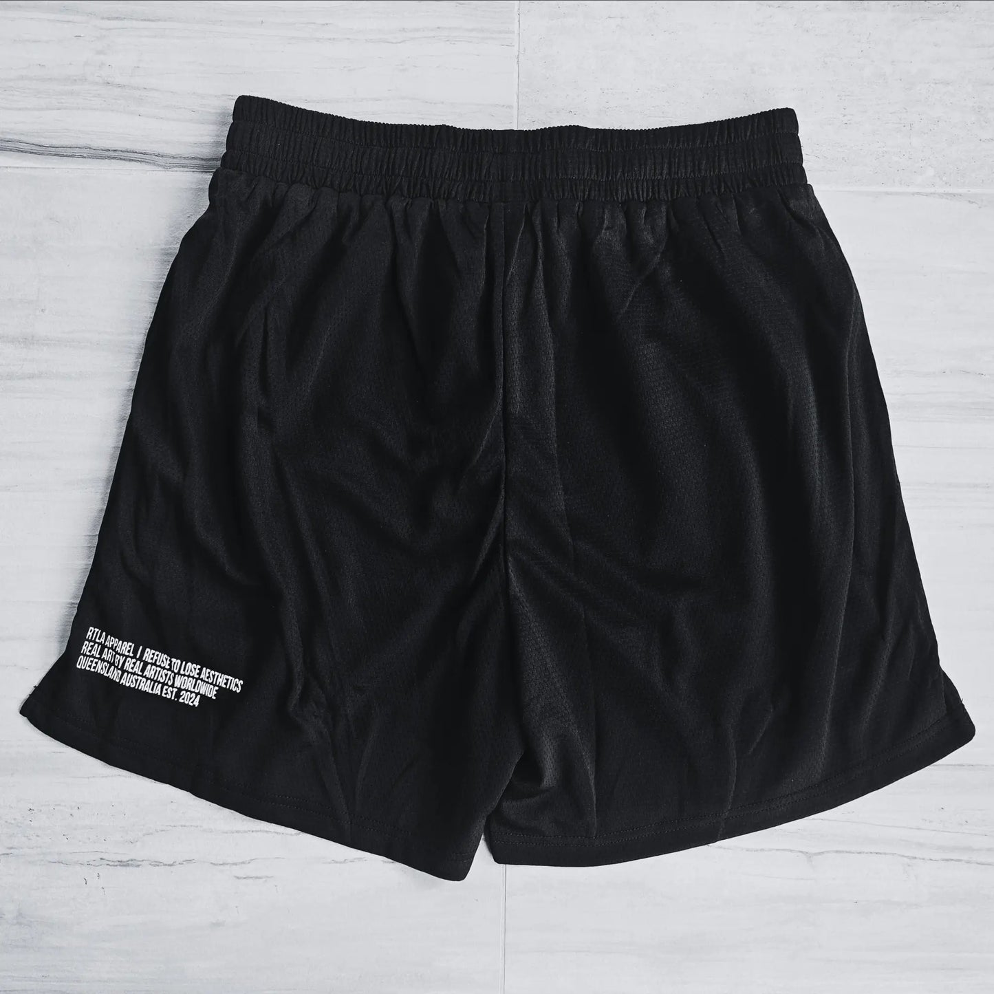 Black shorts with white text on a light gray background