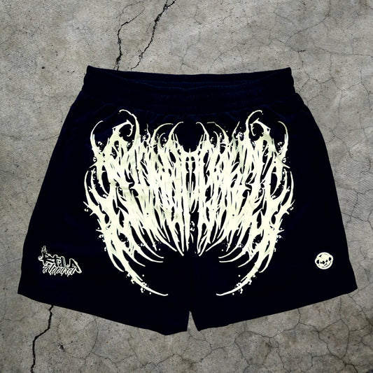 Black shorts with white graphic design on a textured surface
