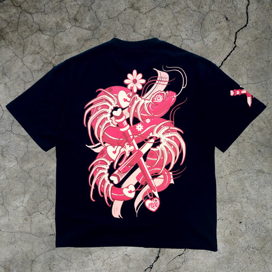 Black t-shirt with pink and white graphic design on a textured gray surface
