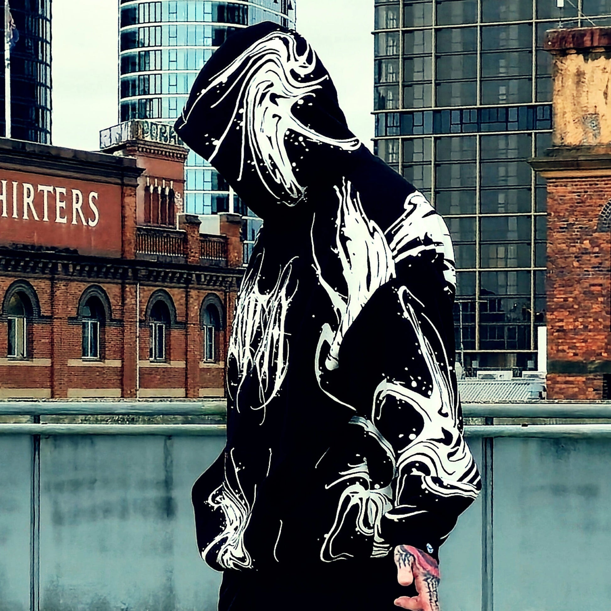 Person wearing a reflective hoodie with urban background
