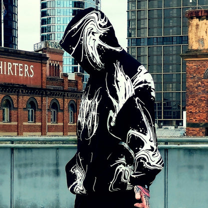Person wearing a reflective hoodie with urban background