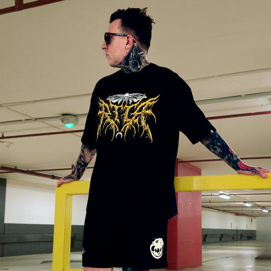 Person wearing a black t-shirt with a graphic design in a parking garage.