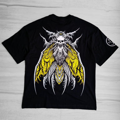 Black t-shirt with a graphic design of a skull with wings on a wooden surface