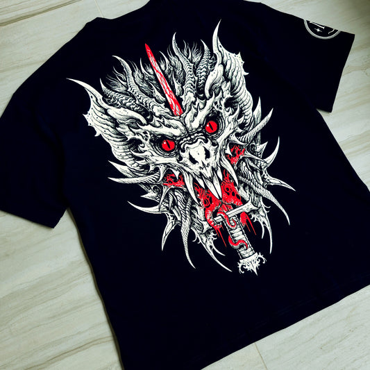 Black t-shirt with a dragon graphic design featuring red accents on a wooden surface.