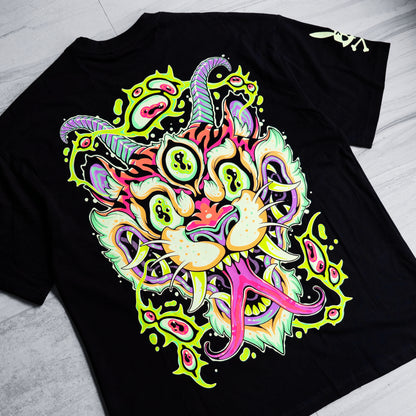 Black t-shirt with a colorful, abstract design on a light gray surface