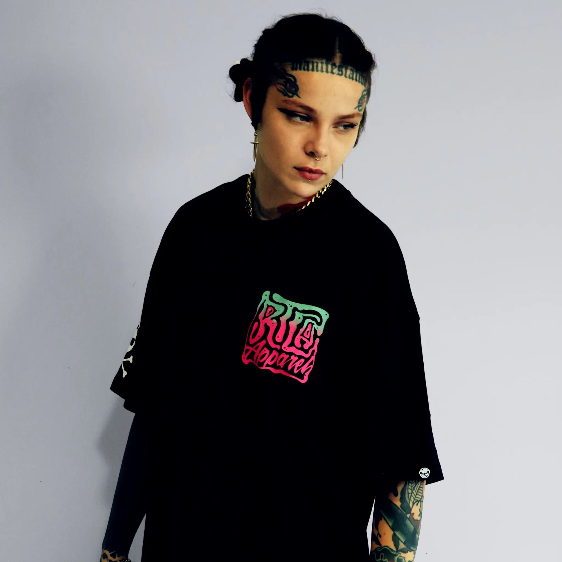 Person wearing a black sweatshirt with colorful text design on a plain background