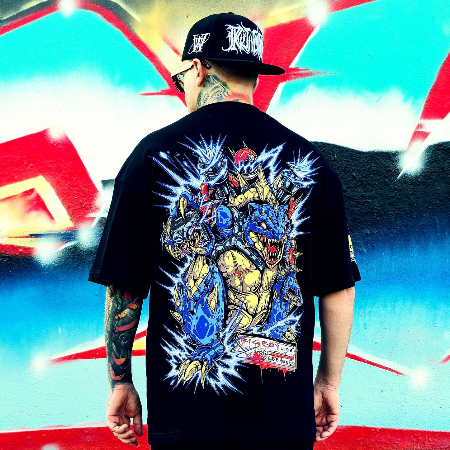 Person wearing a black t-shirt with colorful graphic design, standing against a vibrant, abstract background.