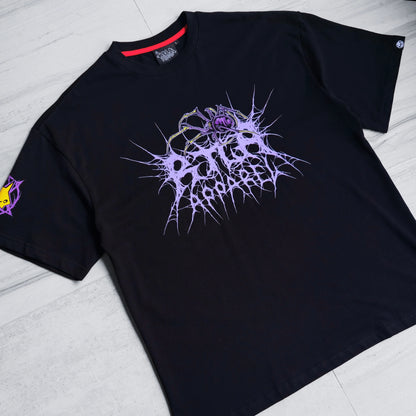 Black t-shirt with a purple and white abstract design on a light wooden floor.