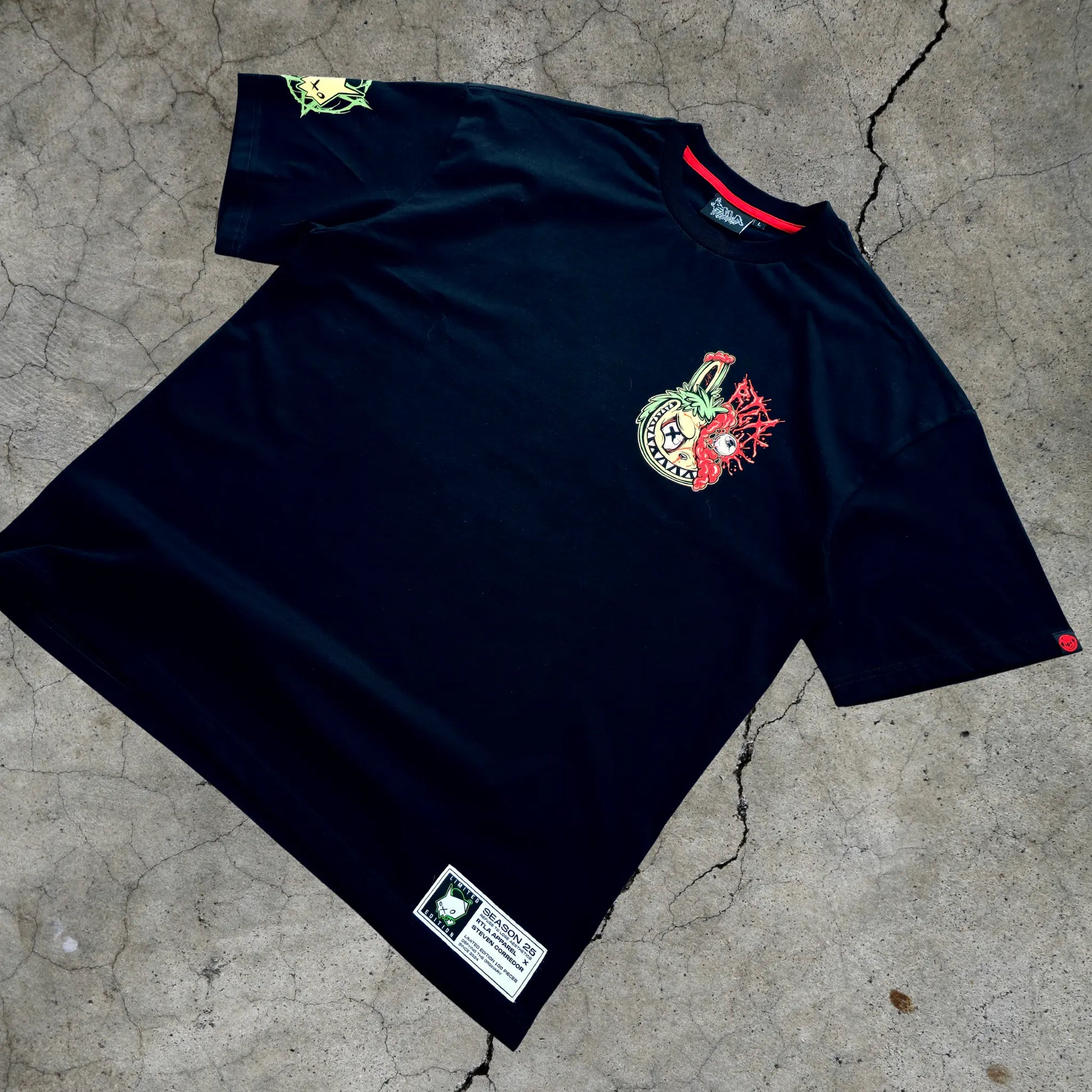 Black sports jersey with logos on a concrete surface