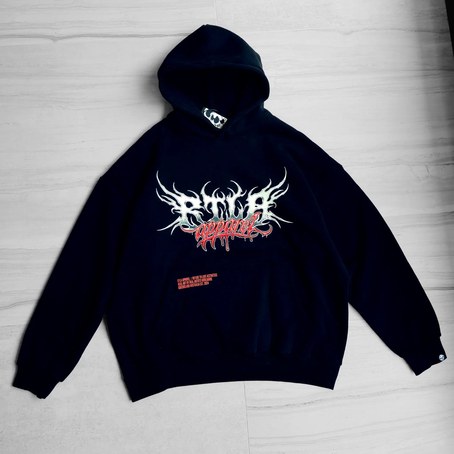 Black hoodie with white and red graphic design on a light gray background