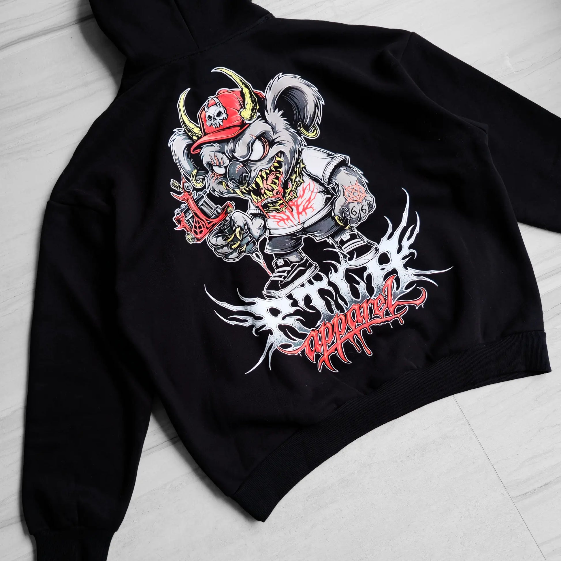 Black hoodie with a graphic design of a skeleton in a top hat and coat on a light gray surface.