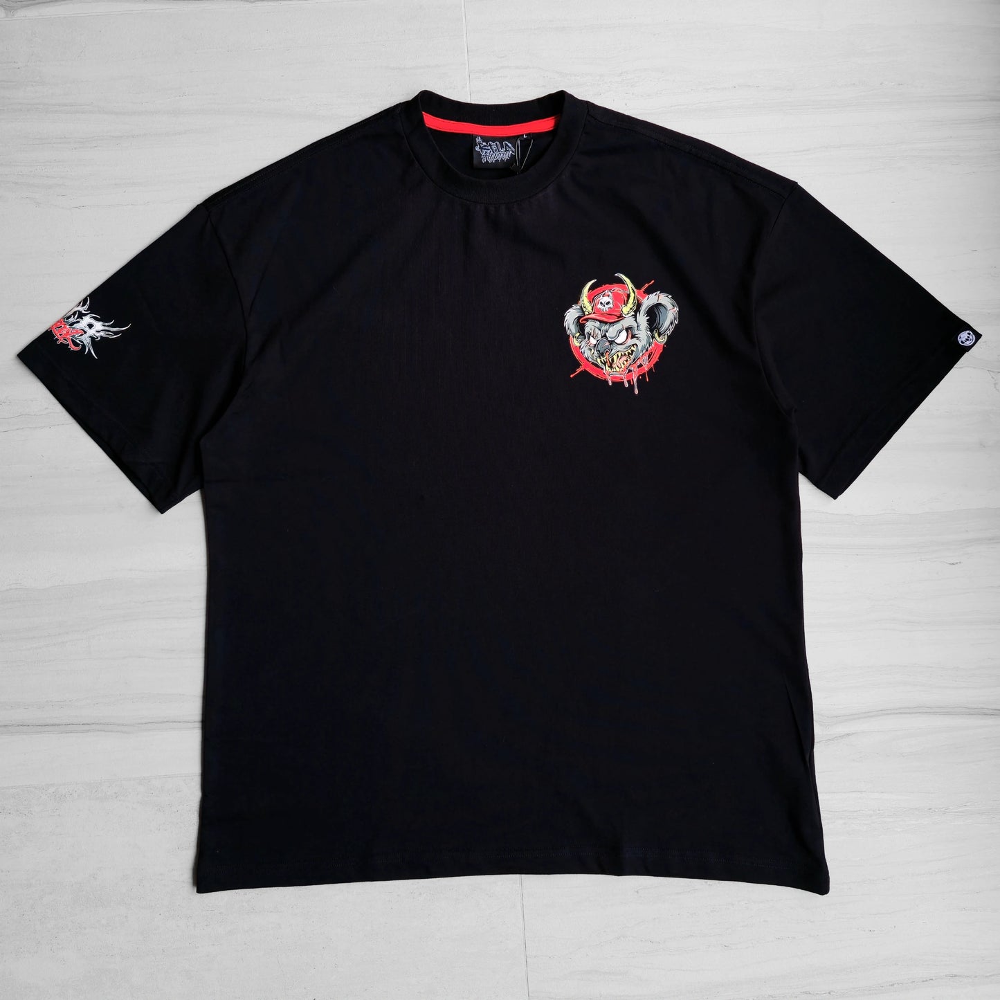 Black t-shirt with a graphic design on a light gray background