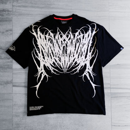 Black t-shirt with white abstract design on a gray wooden surface