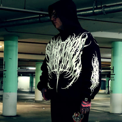 Person wearing a black hoodie with white design in front and back