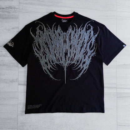 Black t-shirt with a large white graphic design on a gray wooden surface