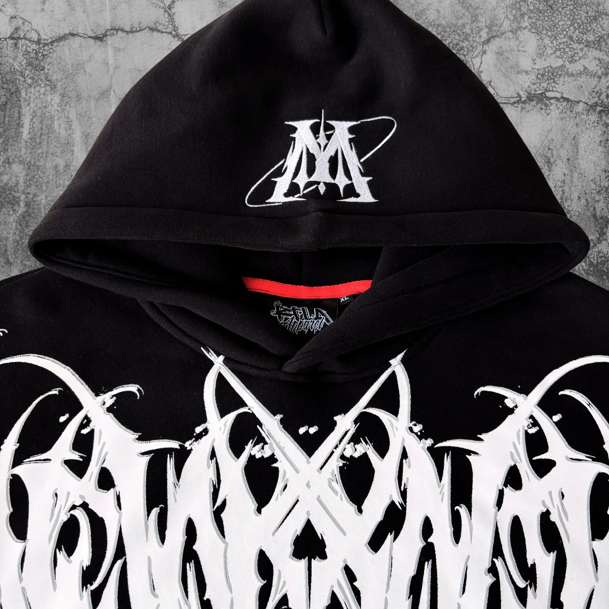 Black hoodie with white and red design on a textured gray background