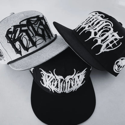Three caps with black and white designs on a white background RTLA-Apparel