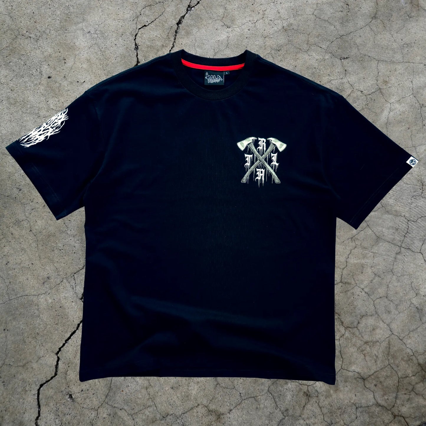 Black t-shirt with white graphic design on a textured gray surface