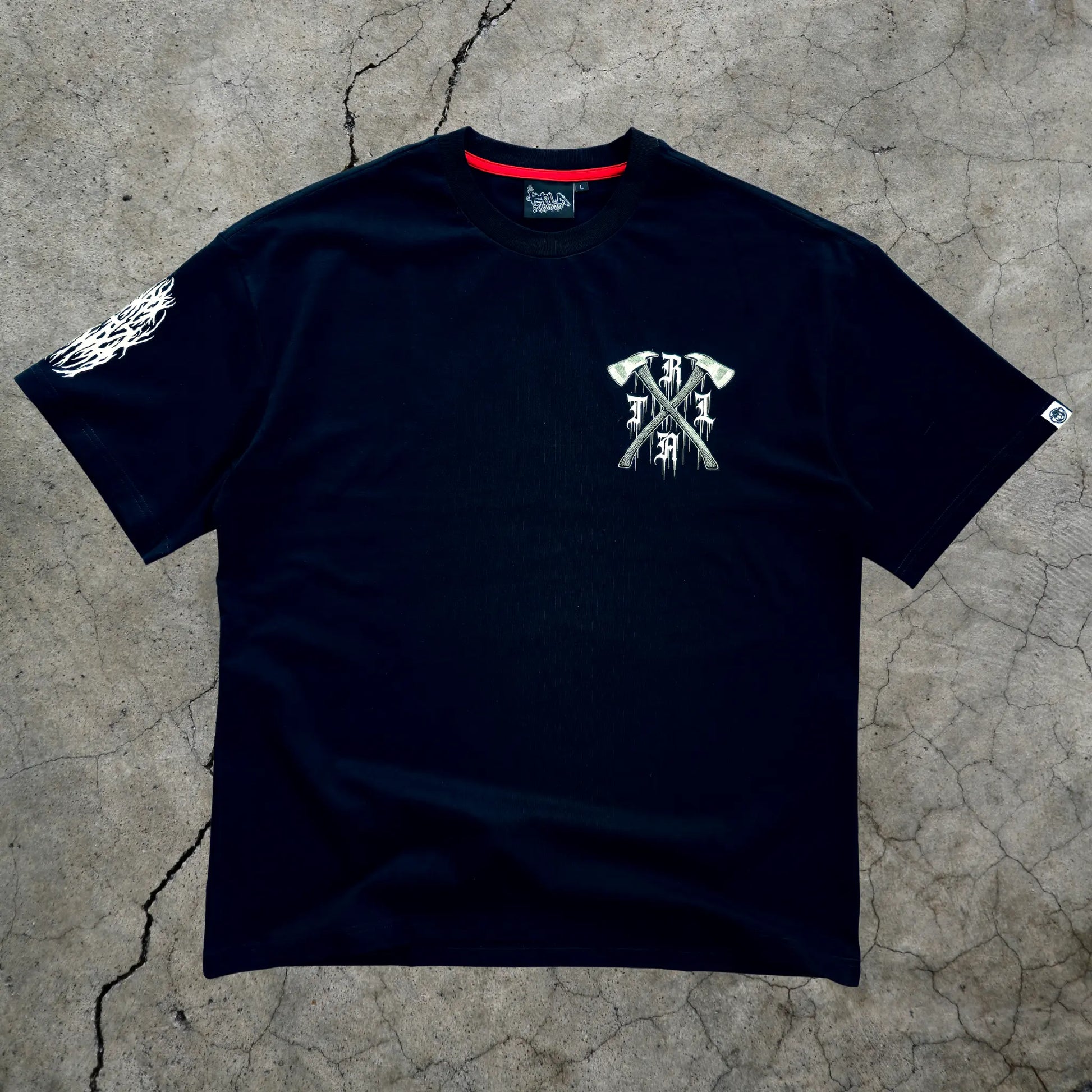 Black t-shirt with white graphic design on a textured gray surface