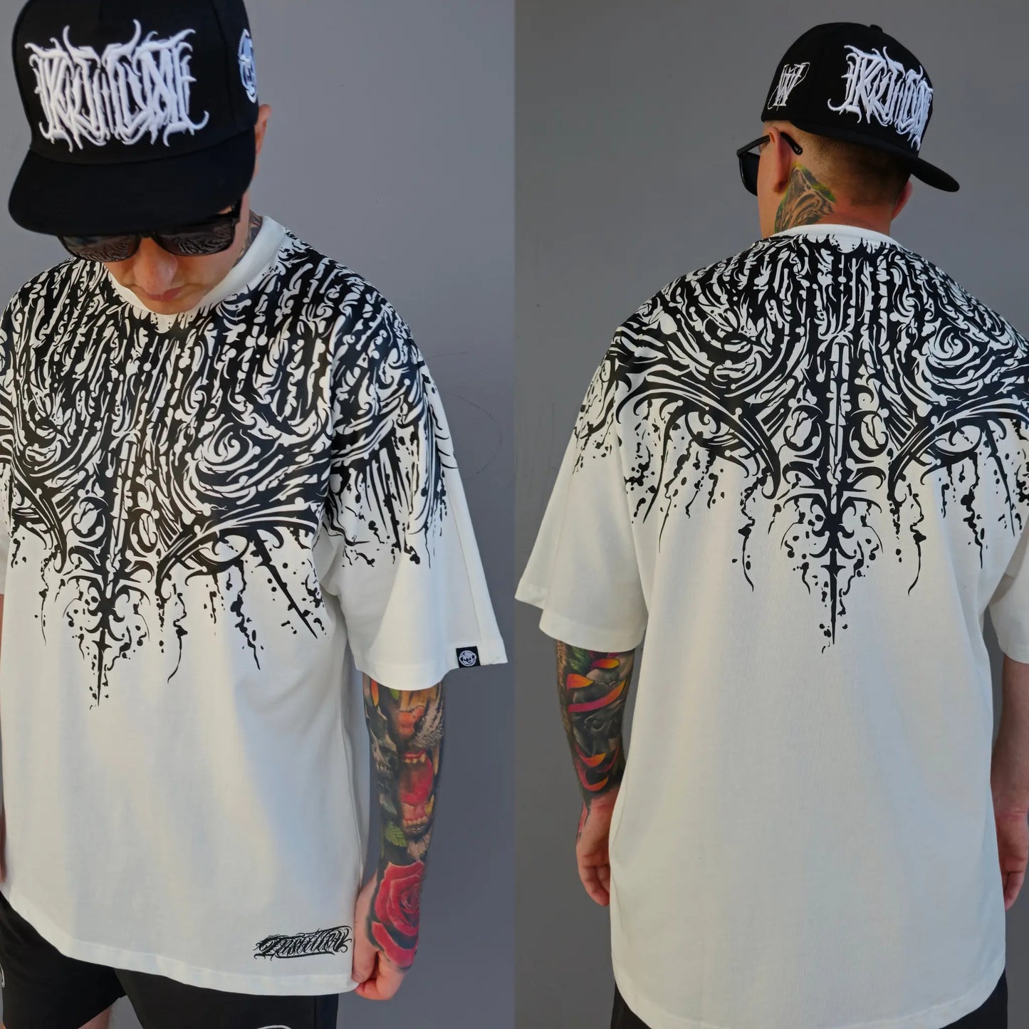 A person wearing a black oversized t-shirt with a white text and script work design, mirrored on both front and back.  RTLA Apparel