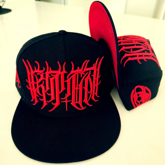 Black caps with red designs on a white surface