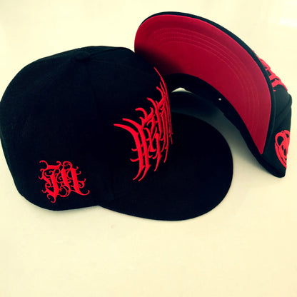 Two black caps with red designs on a beige background