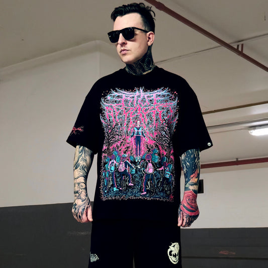 Man wearing a black t-shirt with colorful graphic design in an indoor setting