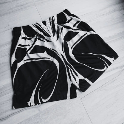 Black and white patterned shorts on a light wooden floor