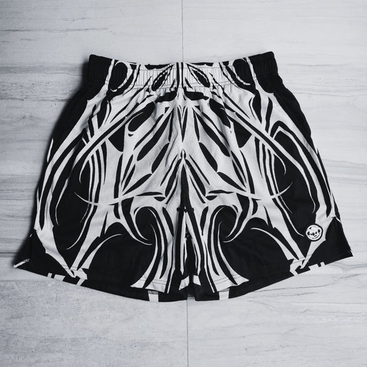 Black and white patterned shorts on a light wooden floor