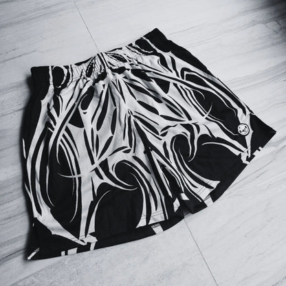 Black and white patterned shorts on a light wooden floor