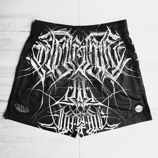 Black shorts with white abstract design on a light wooden floor