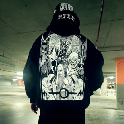 Person wearing a hoodie with a graphic design on the back in an indoor setting