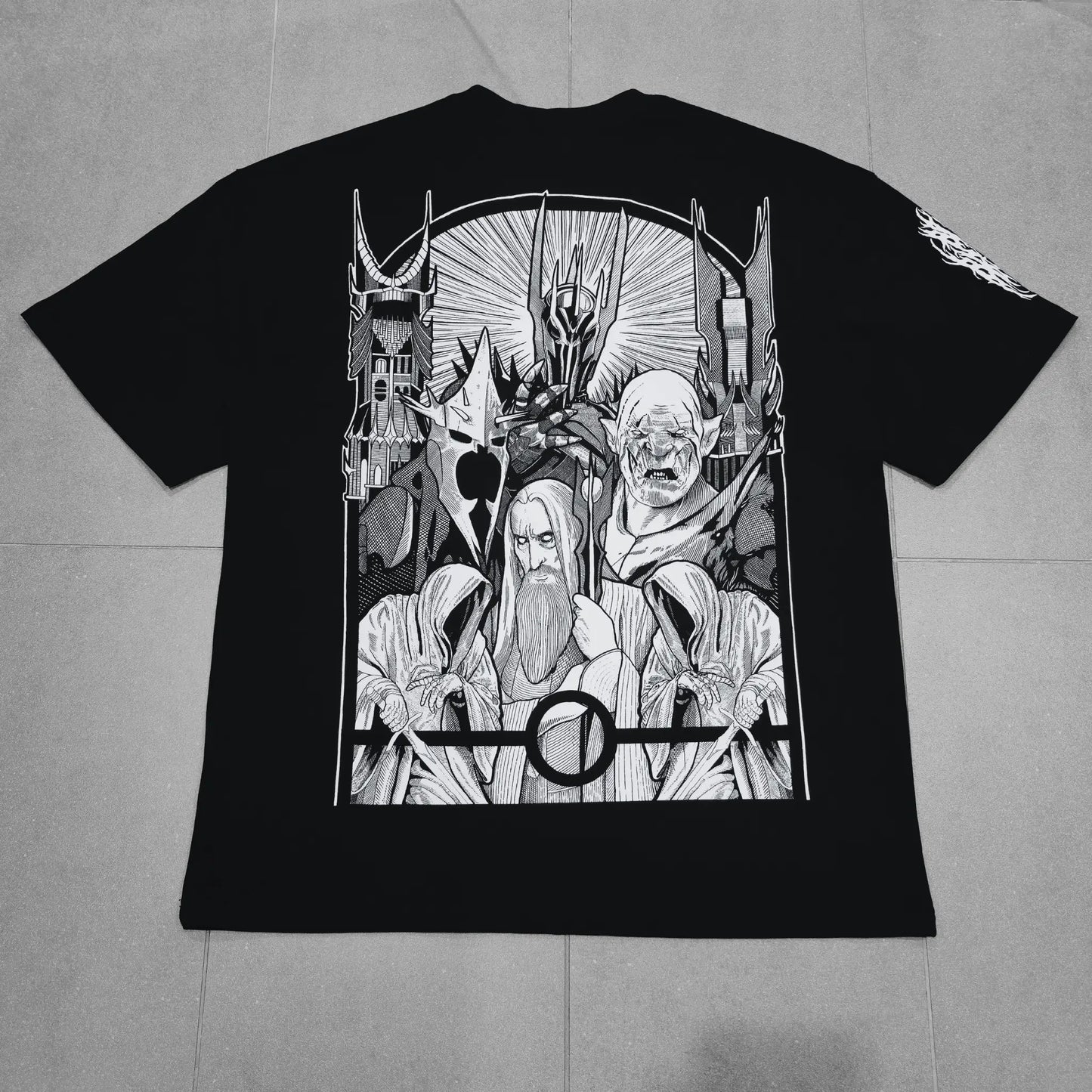 Black t-shirt with white graphic design on a gray surface
