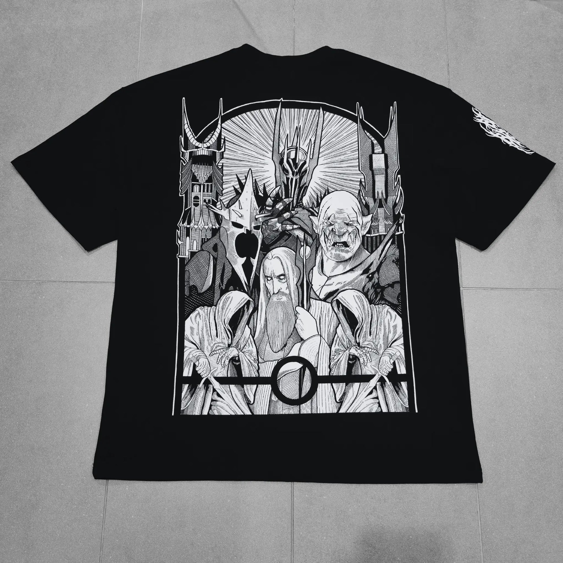 Black t-shirt with white graphic design on a gray surface