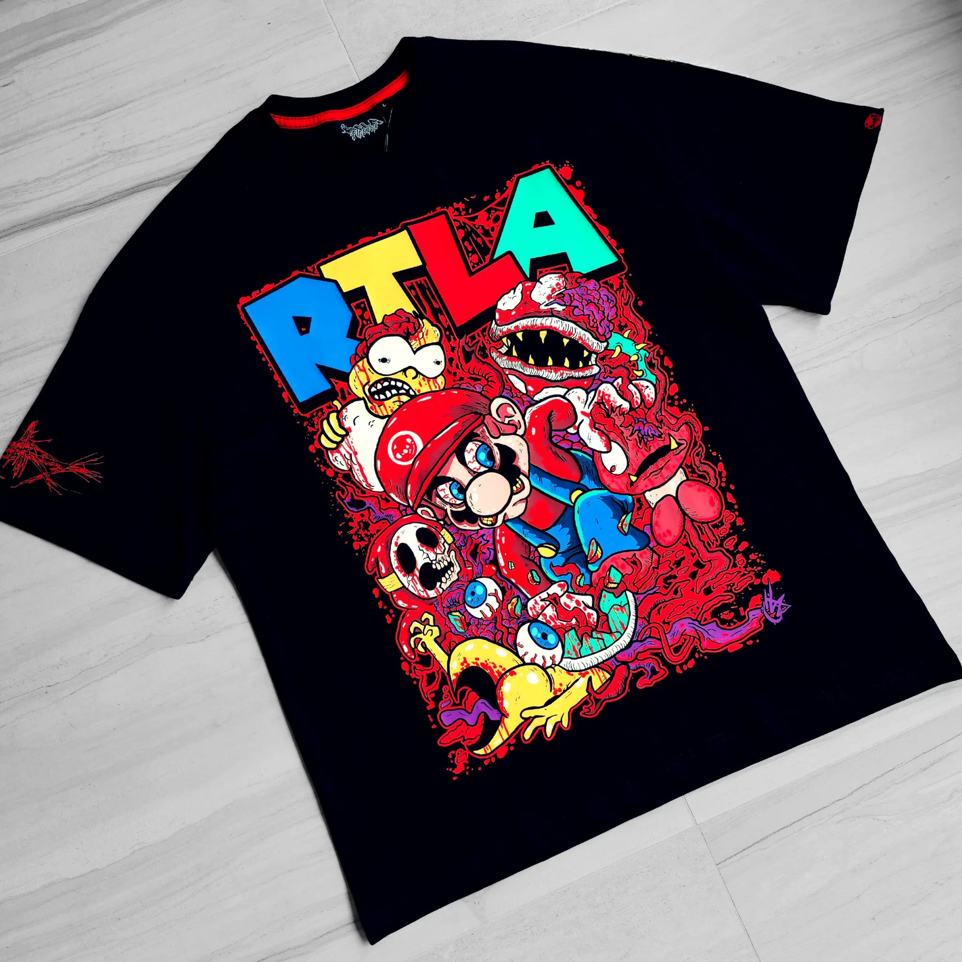 Black t-shirt with colorful graphic design on a light wooden floor