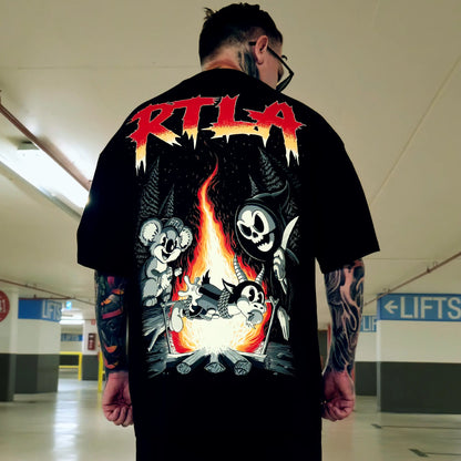 Person wearing a black t-shirt with graphic design and 'RTLA' text in an indoor setting.