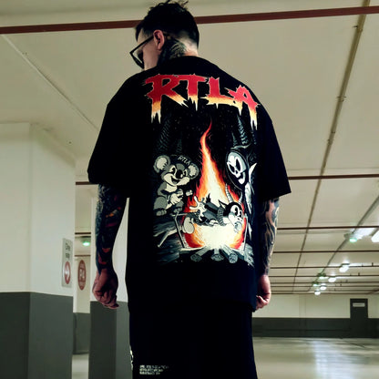 Person wearing a black t-shirt with colorful graphics and 'RTLA' branding in an indoor setting.