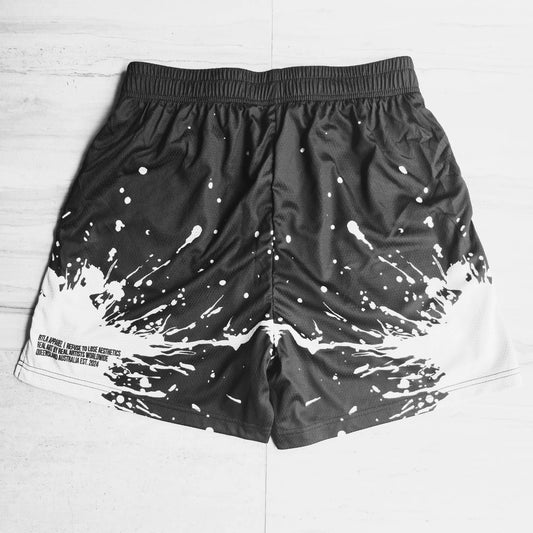 Black shorts with white splatter design on a light gray background