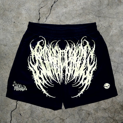 Black shorts with white graphic design on a textured surface