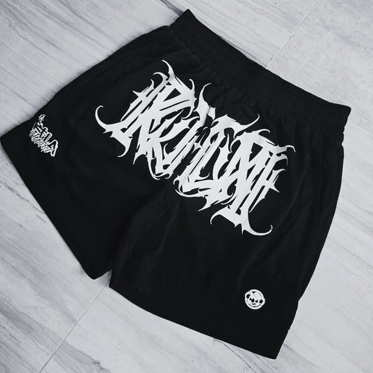 Black shorts with white graphic design on a light gray floor.
