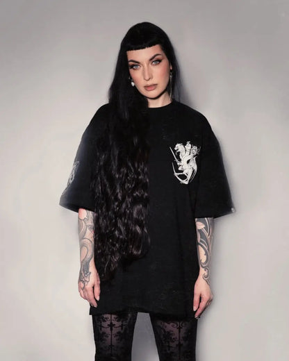 Person wearing a black t-shirt with a white graphic design on a plain background