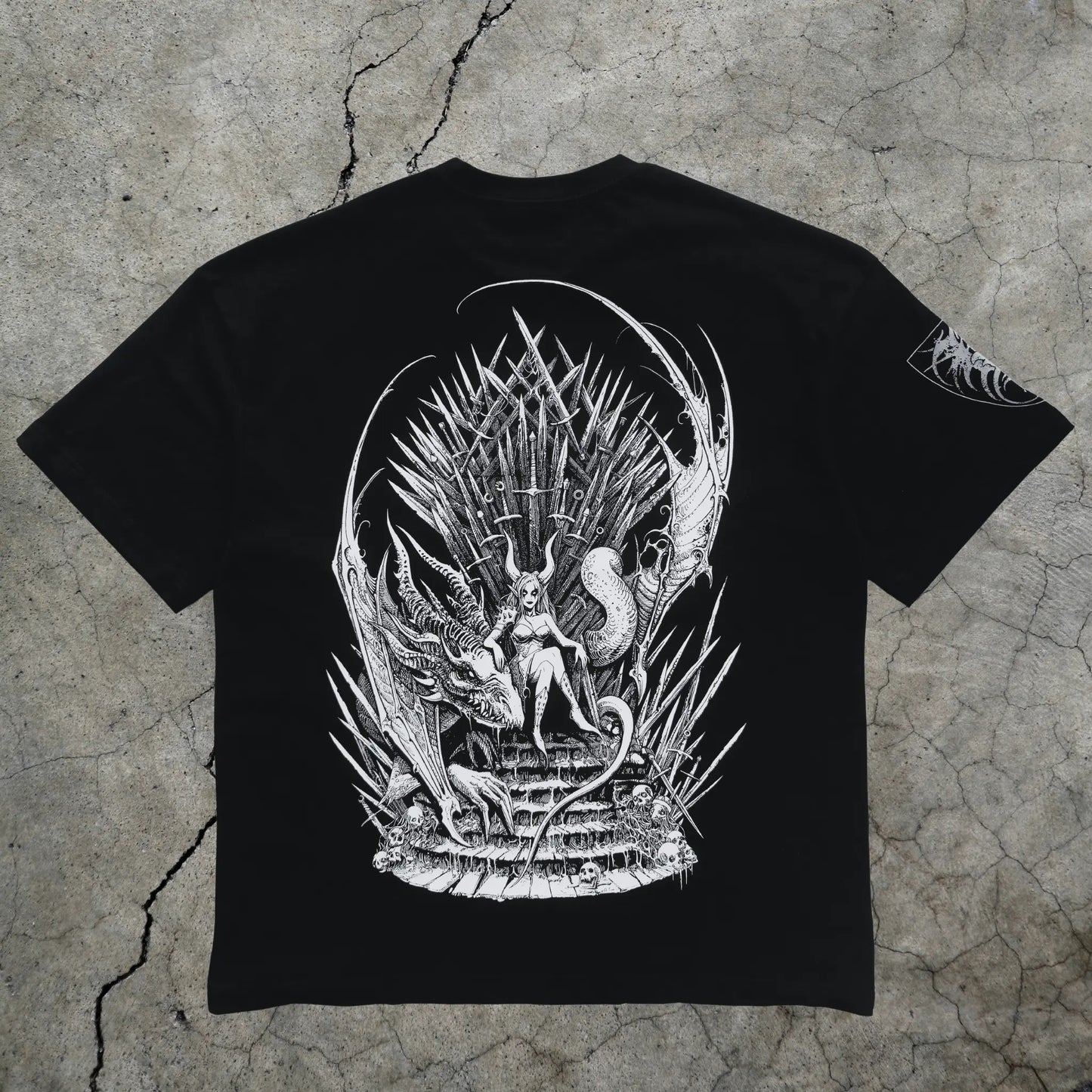 Black t-shirt with white graphic design on a textured gray background