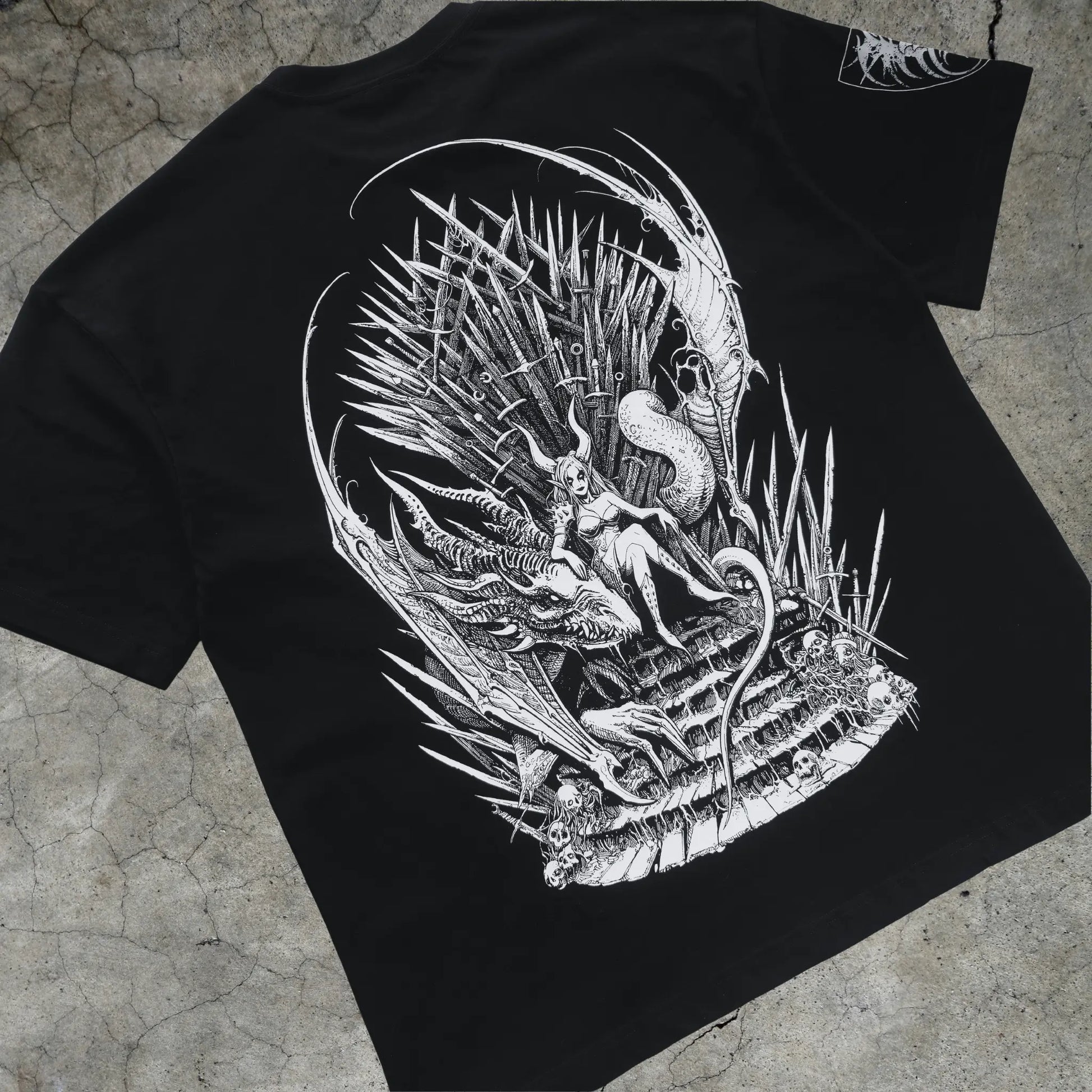 Black t-shirt with a white detailed design on a textured surface